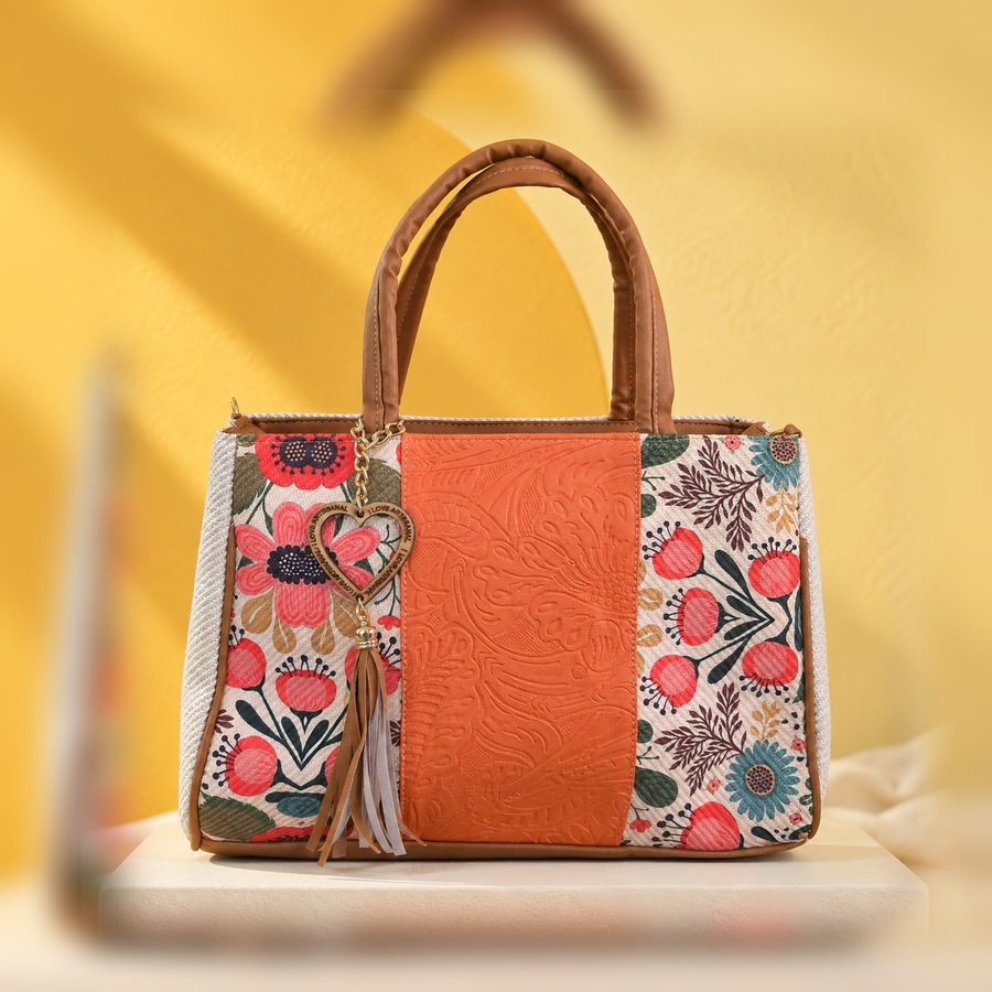 Centered orange floral VidaFeliz tote bag on a bright yellow studio backdrop.